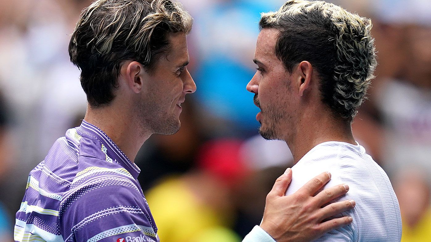Dominic Thiem of Austria and Alex Bolt of Australia meet at the net after their second round match