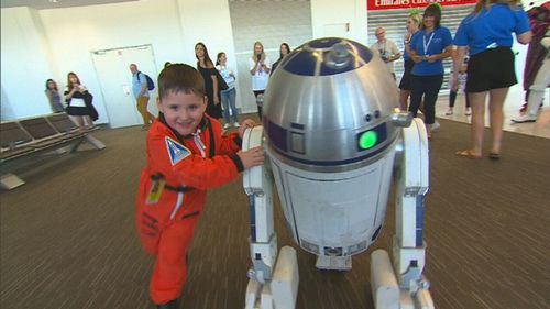 The four-year-old had a very special escort through the airport. (9NEWS)