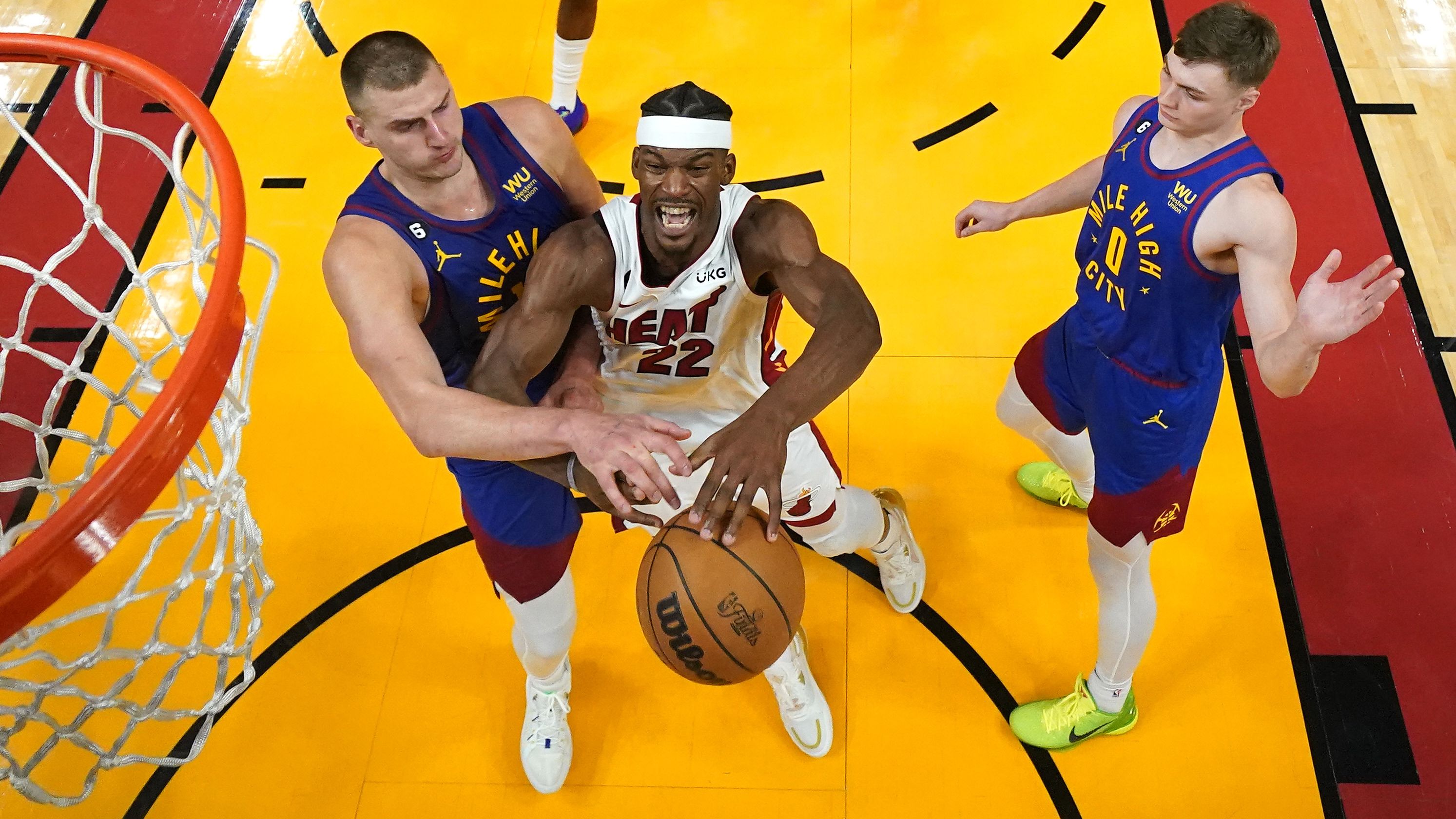 Jun 7, 2023; Miami, Florida, USA; Denver Nuggets center Nikola Jokic (15) knocks the ball away from Miami Heat forward Jimmy Butler (22) during the second half in game three of the 2023 NBA Finals at Kaseya Center. Mandatory Credit: Kyle Terada-USA TODAY Sports