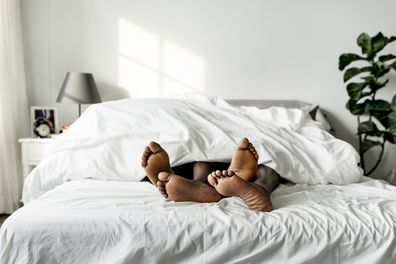 Couple lying on bed together