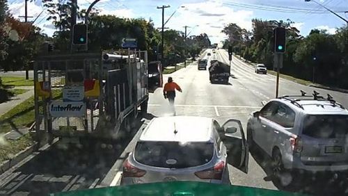 Another truck driver can be seen pulling up and getting out of the car to check on the victim. Picture: News Corp