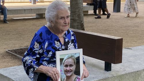 Dell Daniells holds a photo of her daughter Michelle Wolff outside the Brisbane Supreme Court after the sentencing of Jacob Paul Johnston in Brisbane, Wednesday, April 24, 2024. AAP Image/Cheryl Goodenough