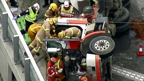 Melbourne driver rushed to hospital after being trapped in truck rollover 