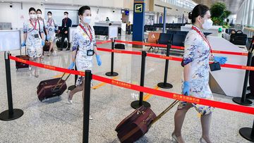 Hainan Airlines flight attendants prepare to board a plane at Haikou Meilan International Airport