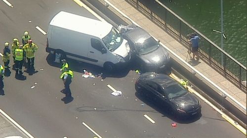 The driver of the white van was taken to hospital with multiple fractures and shock after accidentally running over a driver from a separate collision.