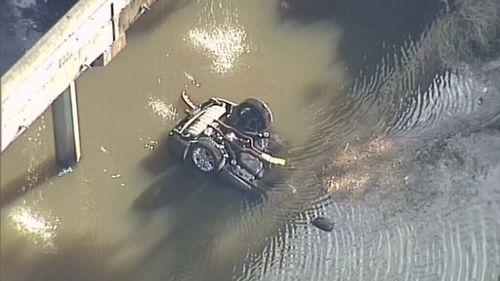 A vehicle fell from the truck into the water below. (9NEWS)