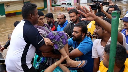 Thousands of people stranded on their rooftops have been evacuated after unprecedented flooding in the southern Indian state of Kerala killed more than 320 people over nine days.