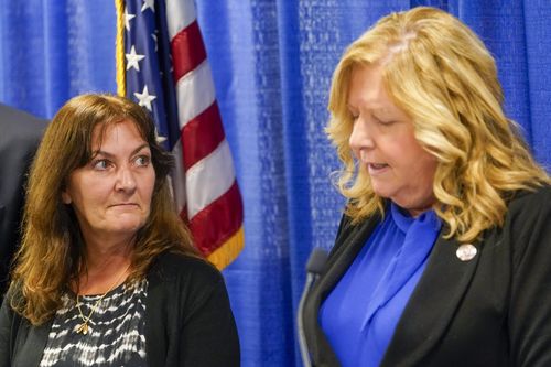 Darlene Altman, left, daughter of Diane Cusick, looks on as Nassau County District Attorney Anne Donnelly speaks during a news conference, Wednesday, June 22, 2022, in Mineola, NY More than 50 years after a woman was found dead in her car at a mall on Long Island, authorities prosecutors are expected to announce that DNA evidence has linked the slaying to Richard Cottingham, a serial killer who has been connected to 11 murders in New York and New Jersey between 1965 and 1980. (AP Photo/Mary Al