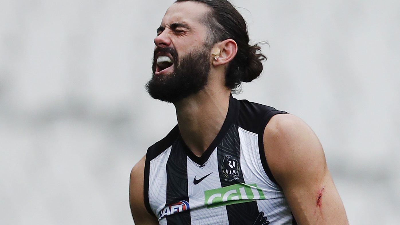 Brodie Grundy of the Magpies reacts after sustaining an injury during the Round 11 match between the Collingwood Magpies and the Geelong Cats at the MCG.