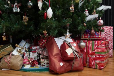close up shot of christmas presents under a christmas tree