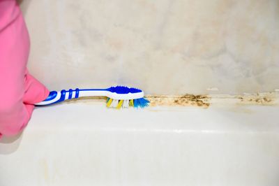 Clean grout and crevices with an old toothbrush