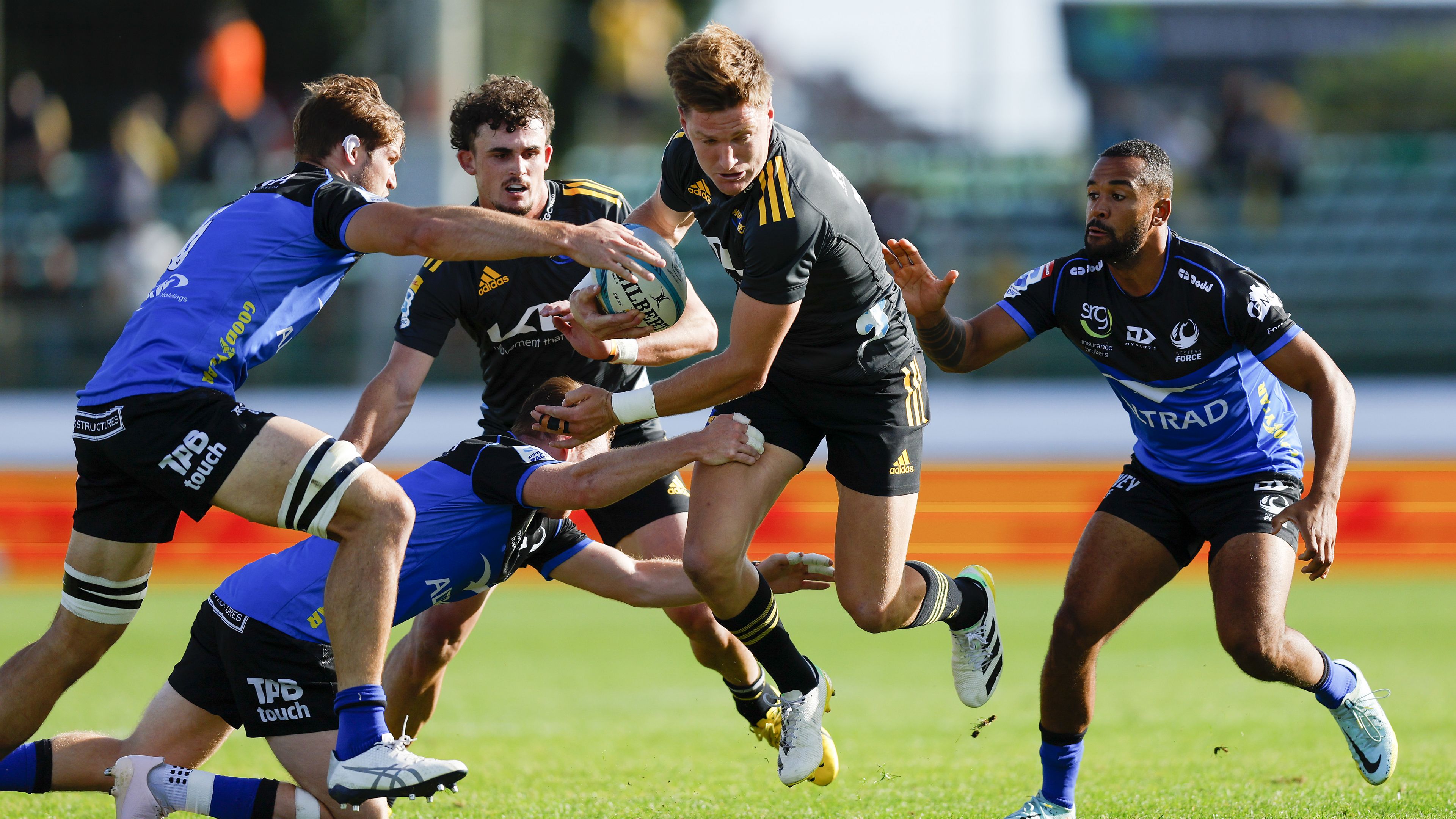 Jordie Barrett of the Hurricanes is tackled in Palmerston North.