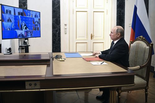 Russian President Vladimir Putin chairs a Security Council meeting via video conference at the Novo-Ogaryovo residence outside Moscow, Russia, Friday, Feb. 18, 2022.