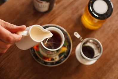 Pouring milk into a cup of tea