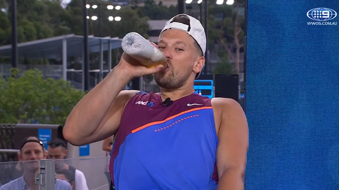 Dylan Alcott drinks from his drink bottle filled up with beer.