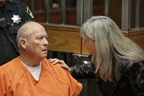 Public defender Diane Howard, right, speaks with Joseph James DeAngelo.