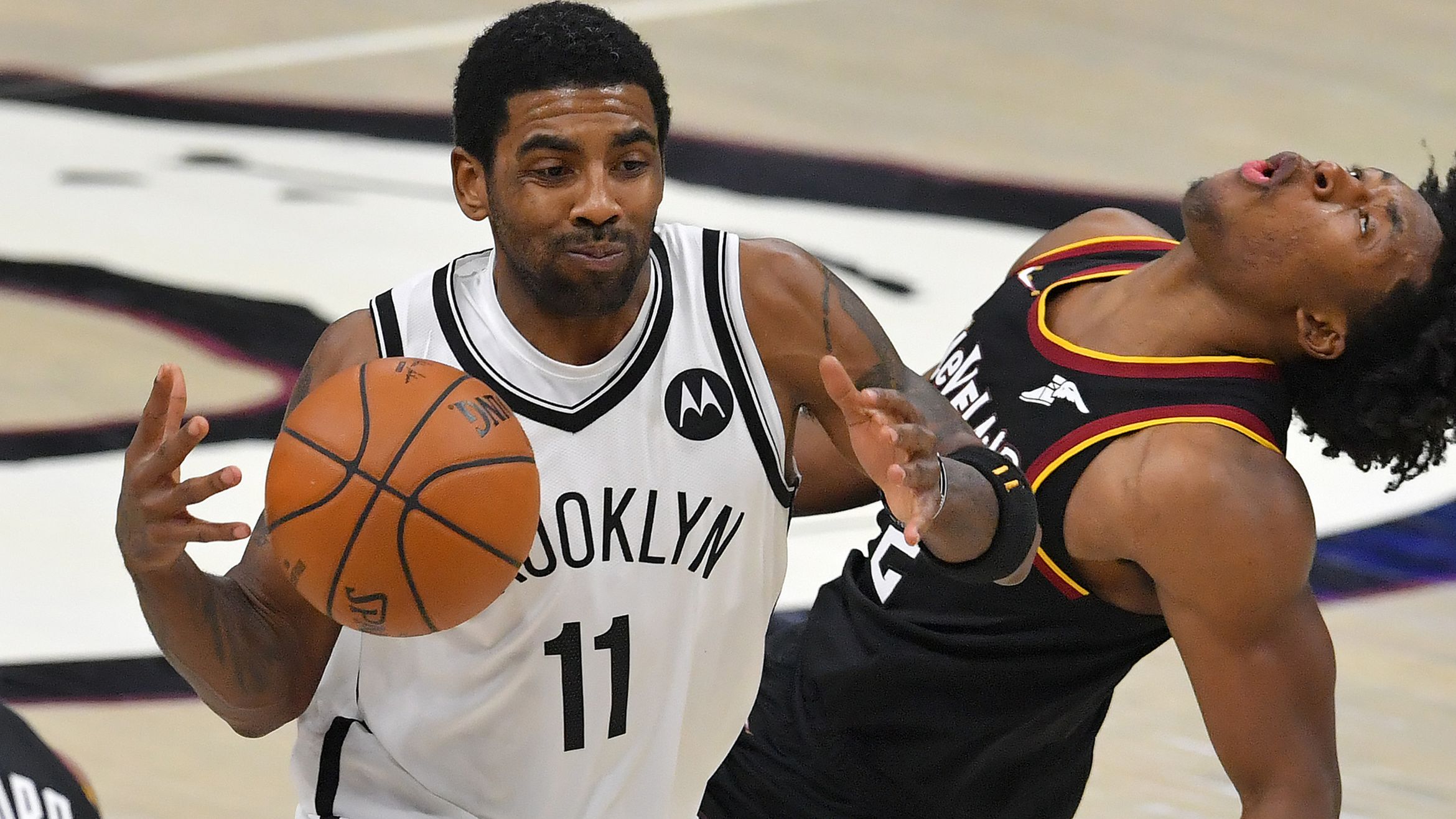 Kyrie Irving of the Brooklyn Nets runs into Collin Sexton of the Cleveland Cavaliers.
