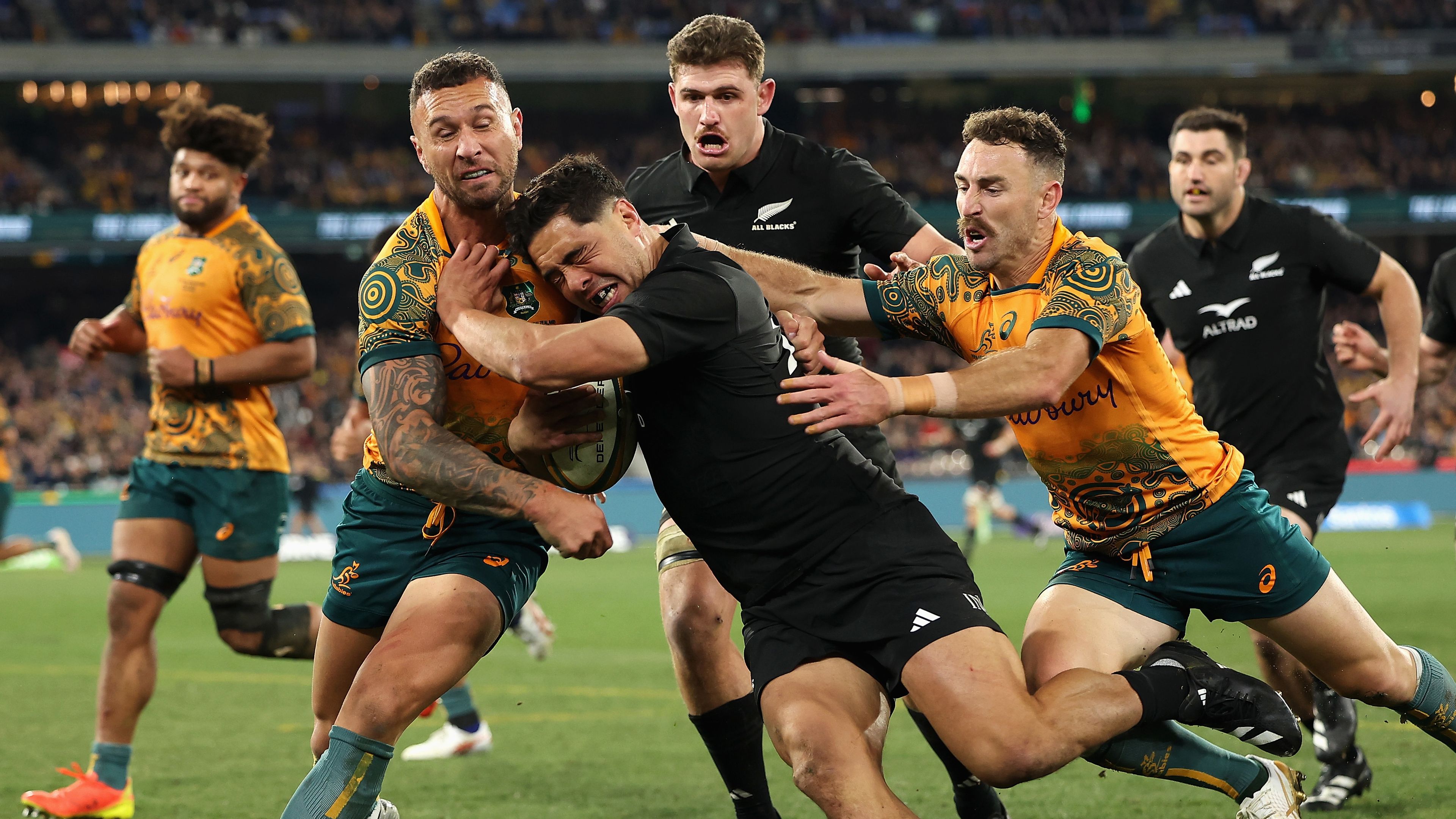 Anton Lienert-Brown of the All Blacks is tackled by Quade Cooper of the Wallabies during the Rugby Championship and Bledisloe Cup.