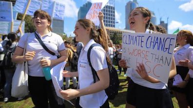 School-age climate change protesters marching in the streets of Sydney.