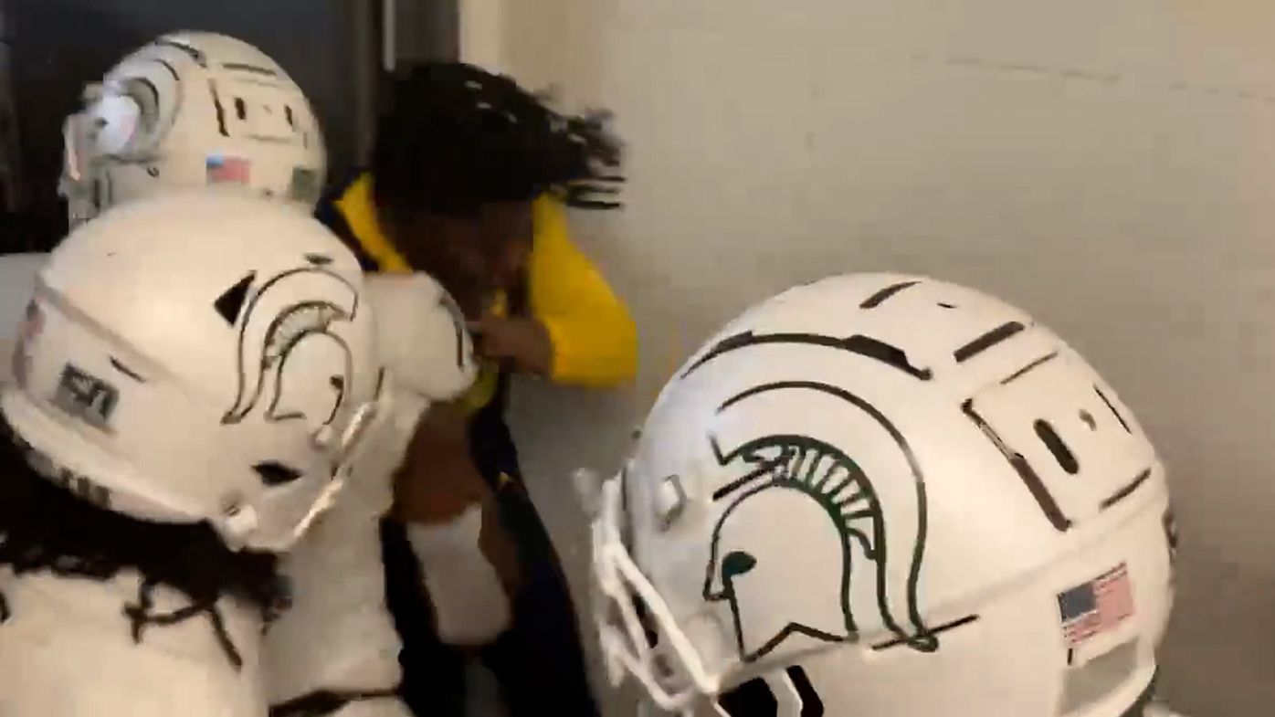A brawl breaks out in a corridor after a match between Michigan State and Wolverines.