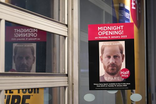A poster advertises the midnight opening of a store to sell the new book by Prince Harry called "Spare" in London, Tuesday, Jan. 10, 2023. 