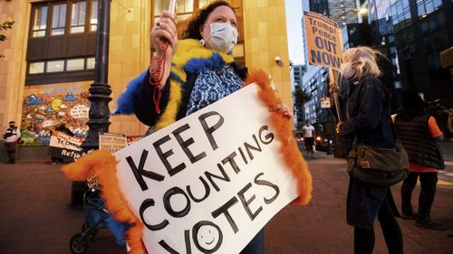 Nancy Shulz protests against President Donald Trump outside Twitter headquarters on Thursday, Nov. 5, 2020, in San Francisco