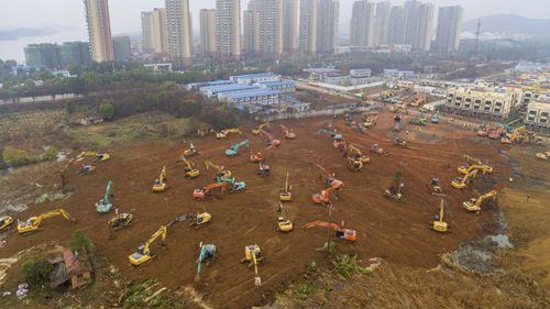 Heavy equipment works at a construction site for a field hospital in Wuhan in central China's Hubei Province.