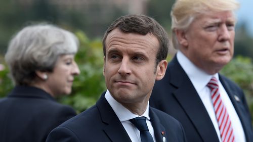 Britain's Prime Minister Theresa May, French President Emmanuel Macron and US President Donald Trump attend the Summit of the Heads of State and of Government of the G7