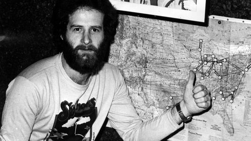 Michael Gudinski points to a map showing one of his first signings, the Skyhooks', tour of America.