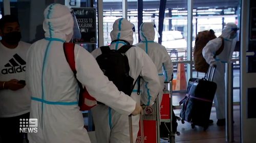 Passengers who arrive back in Sydney wearing hazmat suits.