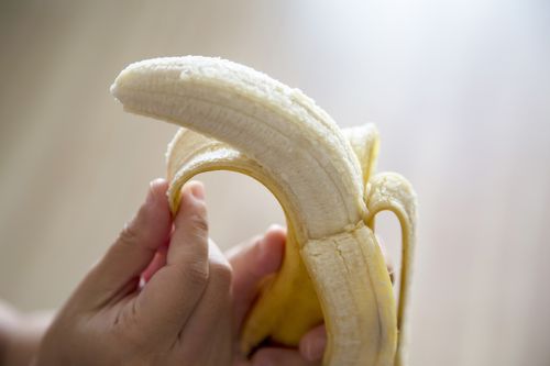 peeling a banana by hand