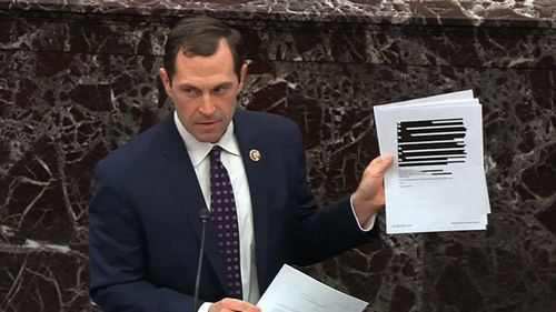 House impeachment manager Jason Crow presents redacted documents to the Senate.