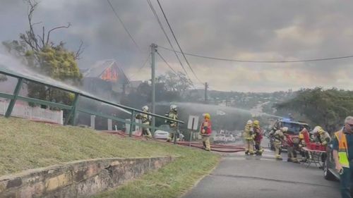 A monster fire that tore through three homes in Brisbane has left three people in hospital, including two firefighters.