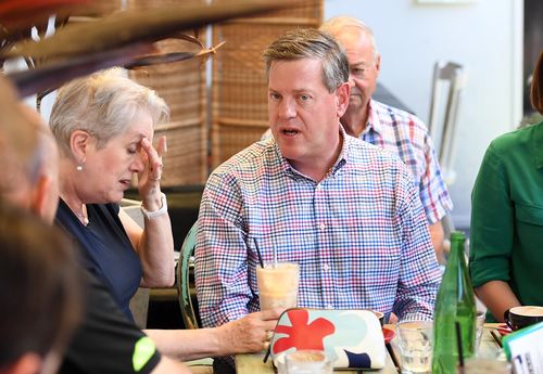 Queensland Opposition Leader Tim Nicholls chats to his mother Barbara as he meets friends and family at a cafe in Brisbane. (AAP)