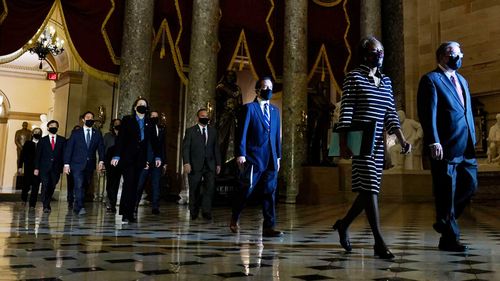 Democratic House impeachment managers walk through the Capitol Rotunda to the Senate to deliver the article of impeachment against former President Donald Trump.