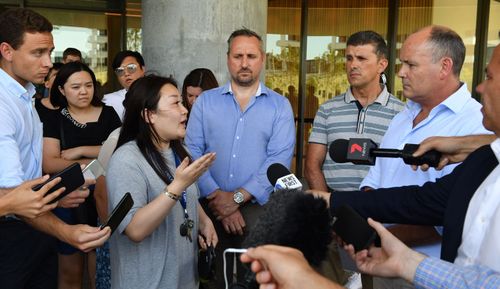 A resident asks questions of Icon Managing Director Julian Doyle at a press conference outside the Opal Tower at Sydney Olympic Park. 