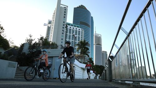 People walking near the Brisbane CBD after lockdown began on July 31, 2021 in Brisbane.