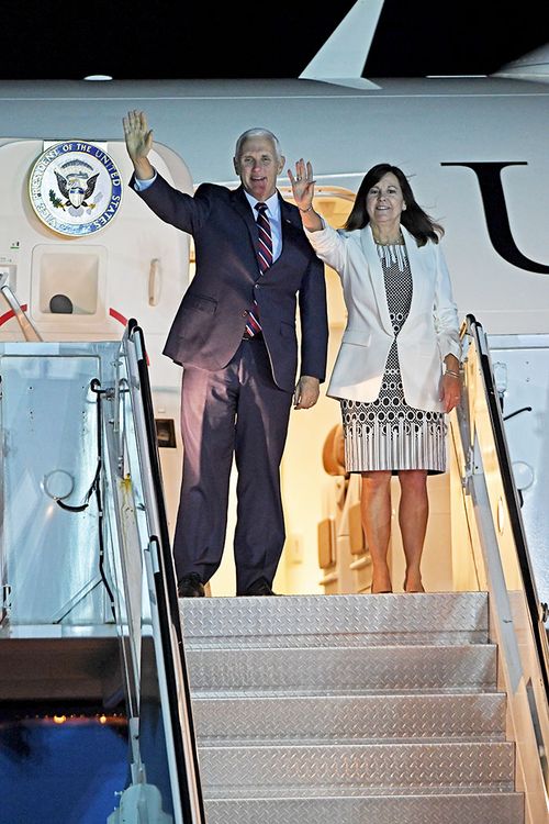 US Vice President Mike Pence and his wife Karen wave as they exit Air Force 2 after arriving in Cairns.