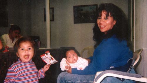 Texas death row inmate Melissa Lucio is holding her daughter Mariah, while one of her other daughters, Adriana, stands next to them. 
