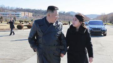 This undated photo provided on Nov. 27, 2022, by the North Korean government shows North Korean leader Kim Jong Un, left, and his daughter, right, walk to a photo session with those involved in the recent launch of what it says a Hwasong-17 intercontinental ballistic missile, at an unidentified location in North Korea. 