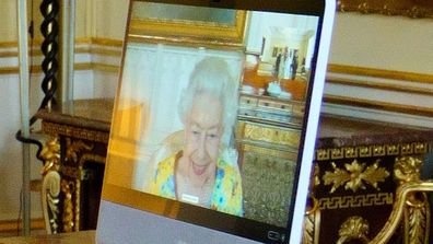 Queen Elizabeth II, in residence at Windsor Castle, appears on a screen via videolink, during a virtual audience to receive the US Ambassador, Jane Hartley, at Buckingham Palace on July 19, 2022 in London, England. 