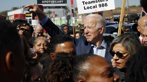 Democratic presidential candidate former Vice President Joe Biden walks on a picket line with members of the Culinary Workers Union Local 226 outside the Palms Casino in Las Vegas.