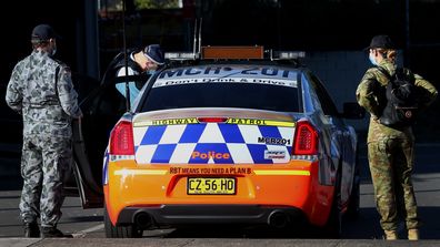 Australian Defence Force personnel and NSW police are seen being deployed from Bankstown Police Station in Sydney.