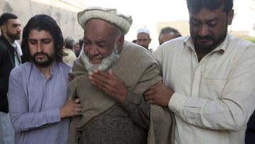 People mourn over the death of their relative, a  police officer killed in the Monday&#x27;s suicide bombing inside a mosque, in Peshawar, Pakistan.