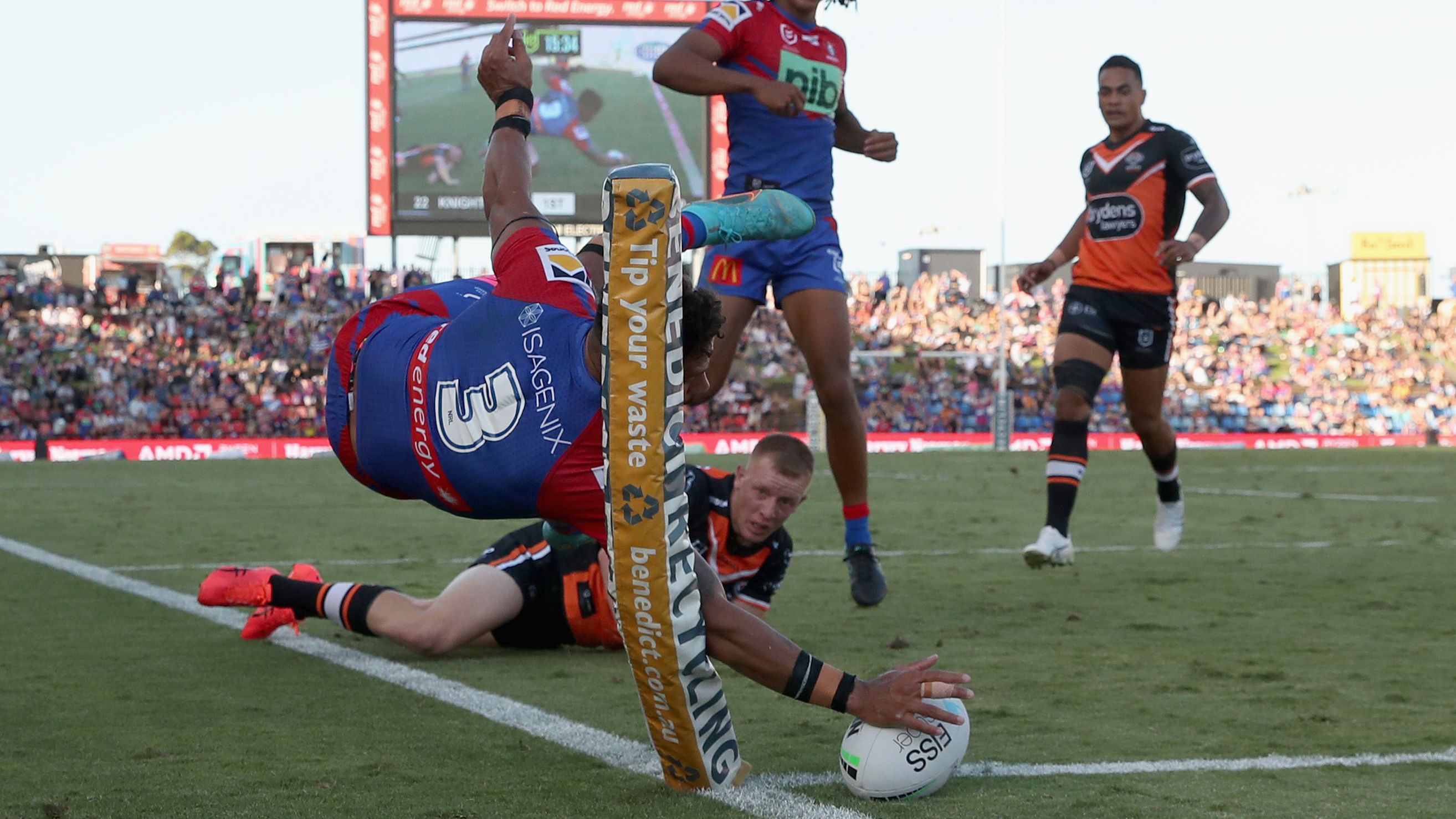 Dane Gagai of the Knights scores a try against the Tigers.