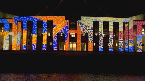 Parliament House has been lit up for Reconciliation Week.