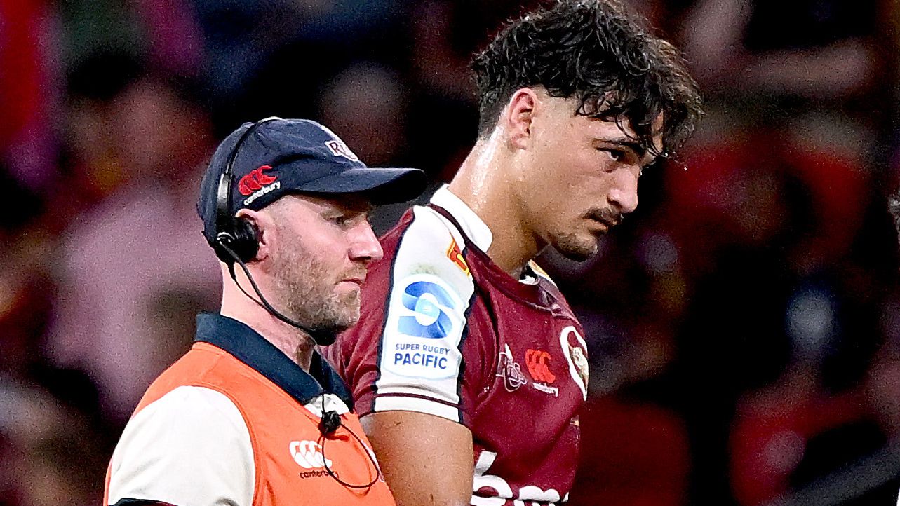 Jordan Petaia of the Reds is taken from the field injured during the round nine Super Rugby Pacific match against the Highlanders.