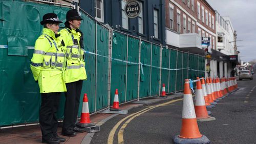 Police officers stand watch near where a Russian double agent and his daughter were poisoned. (AAP)