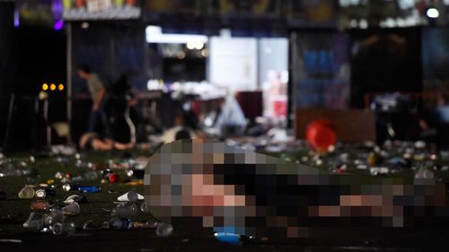 A body, which has been pixelated, lies on the ground amid rubbish at the concert. (Getty Images)
