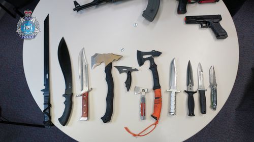 Nearly 20 illegal weapons have been seized from a home in Western Australia by police, including machetes and tasers. 